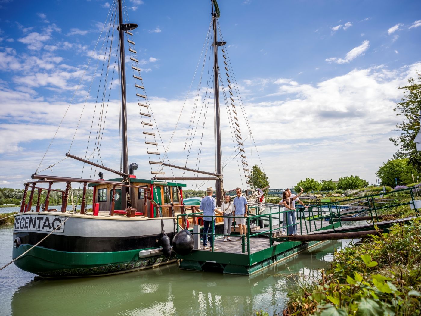 People at the dock in front of the historic Hundertwasser ship "Regentag" 