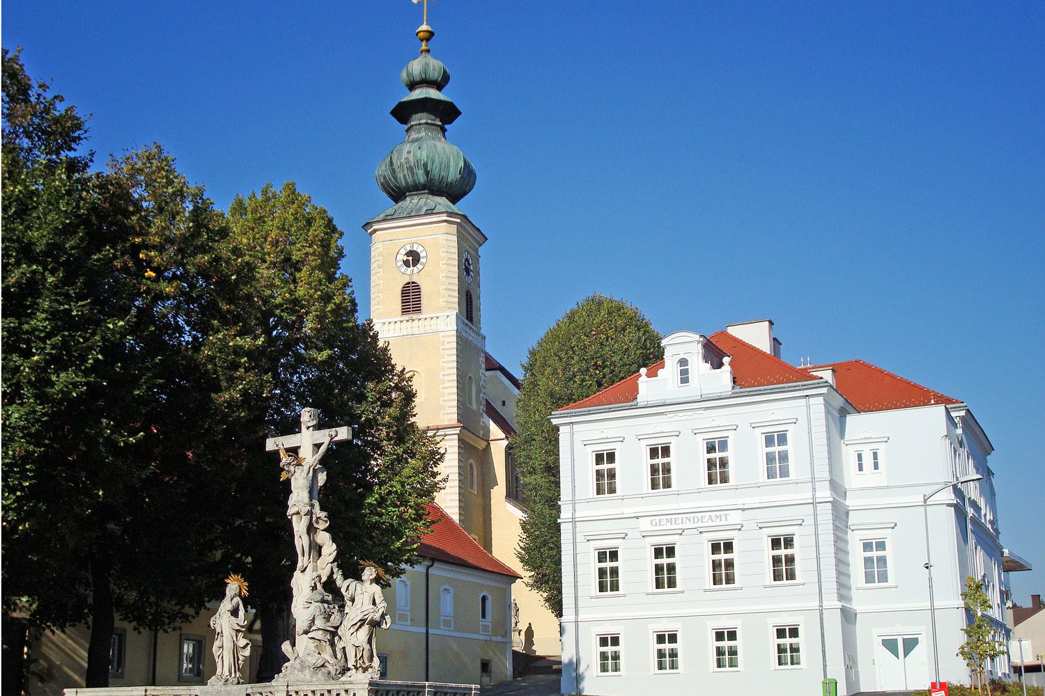 Church with onion dome and parish office in Gaweinstal, Austria.
