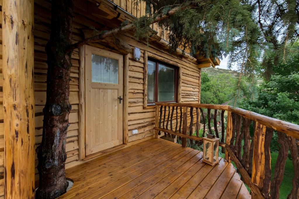Terrace of a wooden tree house with entrance door
