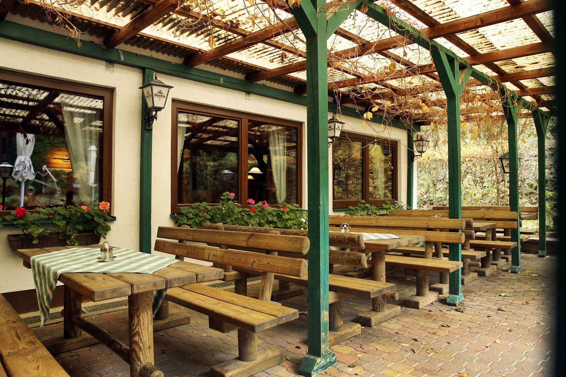 Wooden benches and tables in the garden of a forest inn.