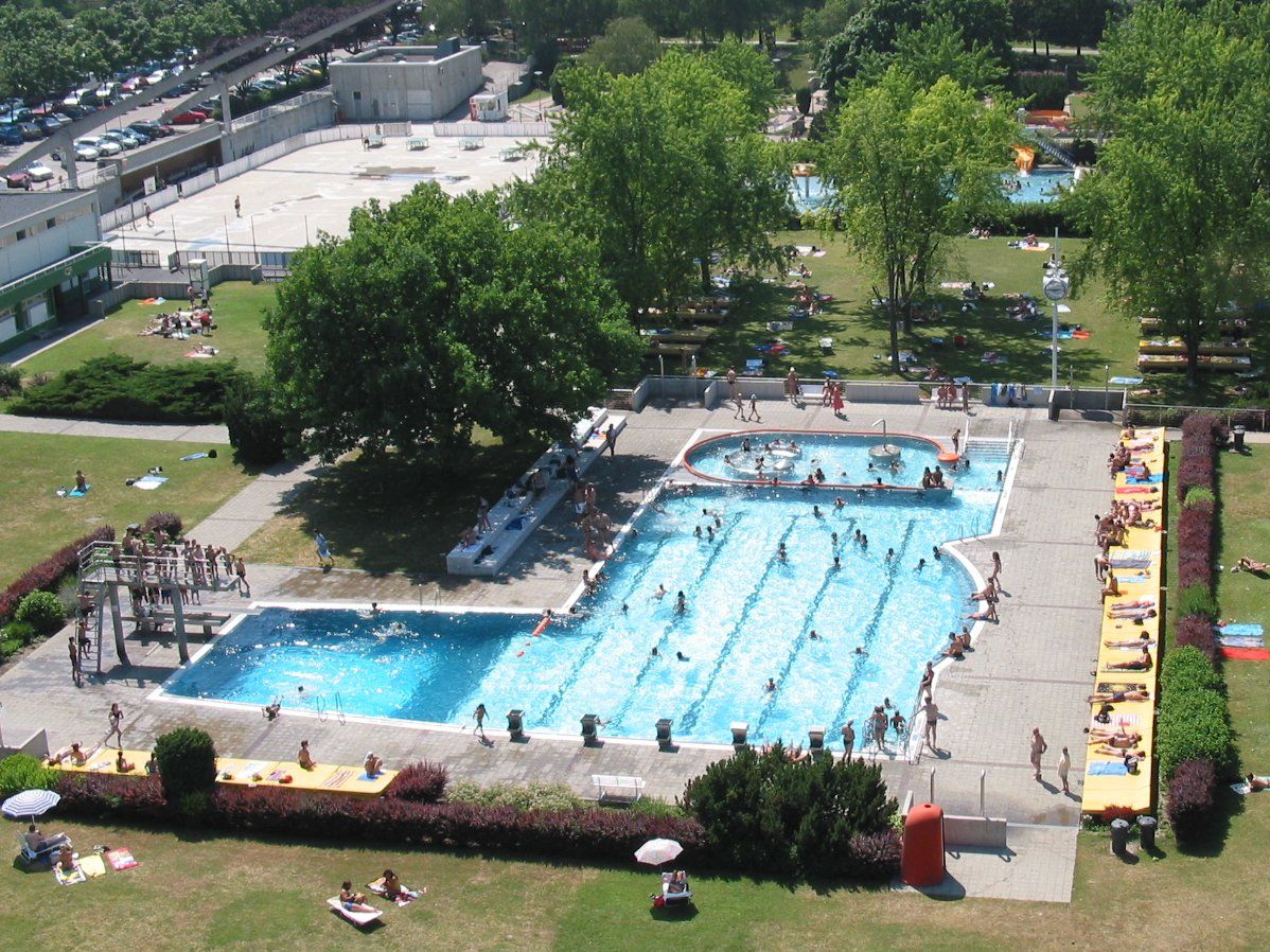 Aerial view of an outdoor pool with swimming pool and sunbathing area.