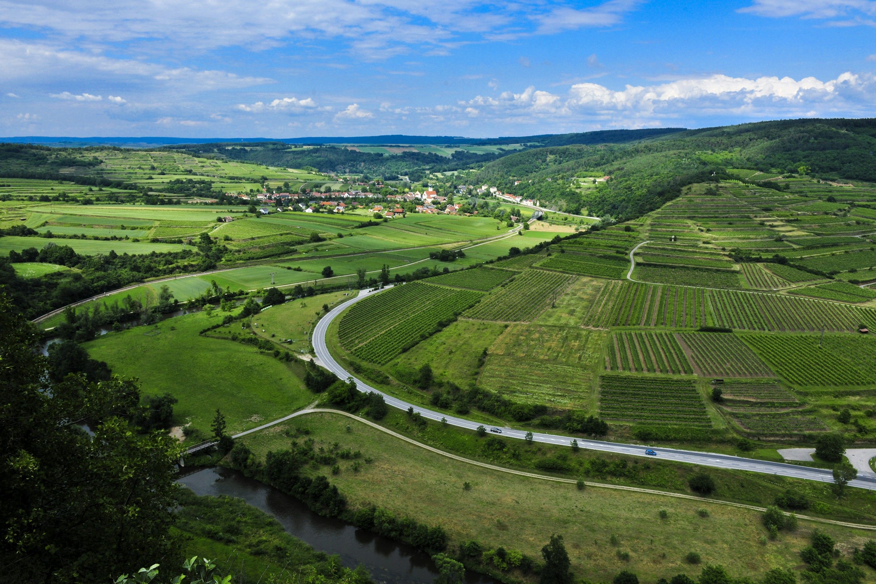 Landscape in the Kamp Valley ("Kamptal" in German) nature park with fields, roads and a river.