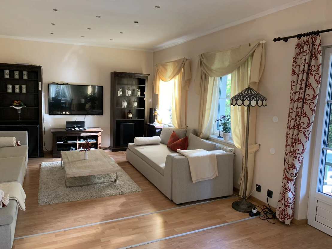 Large, beige living room with two comfortable sofas and access to the terrace