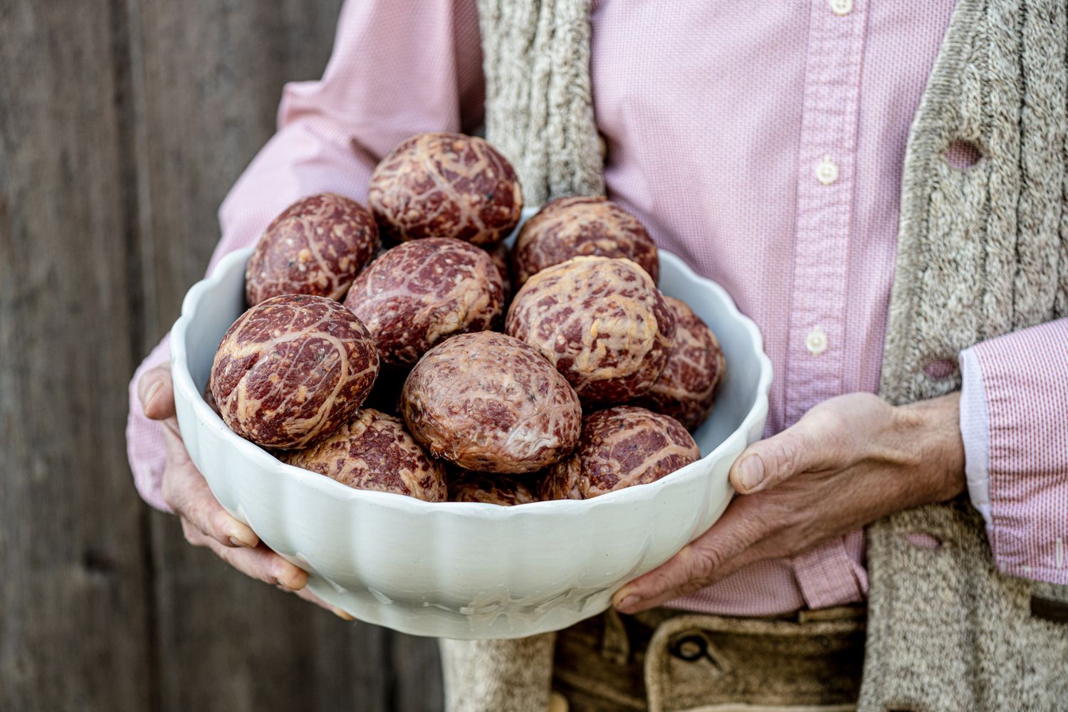 Person holding a bowl of marshmallows.