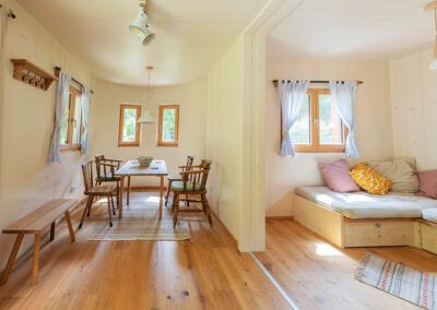 Interior view of a cozy modular house with dining area and sitting area.