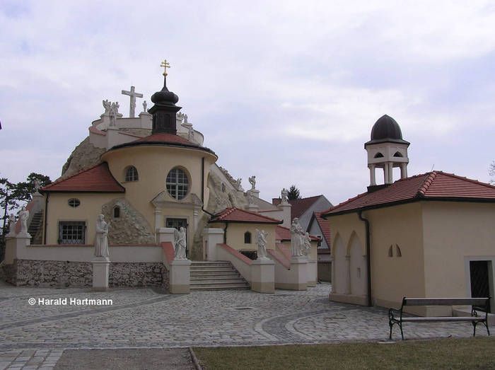 Church in Maria Lanzendorf with statues and bell tower.