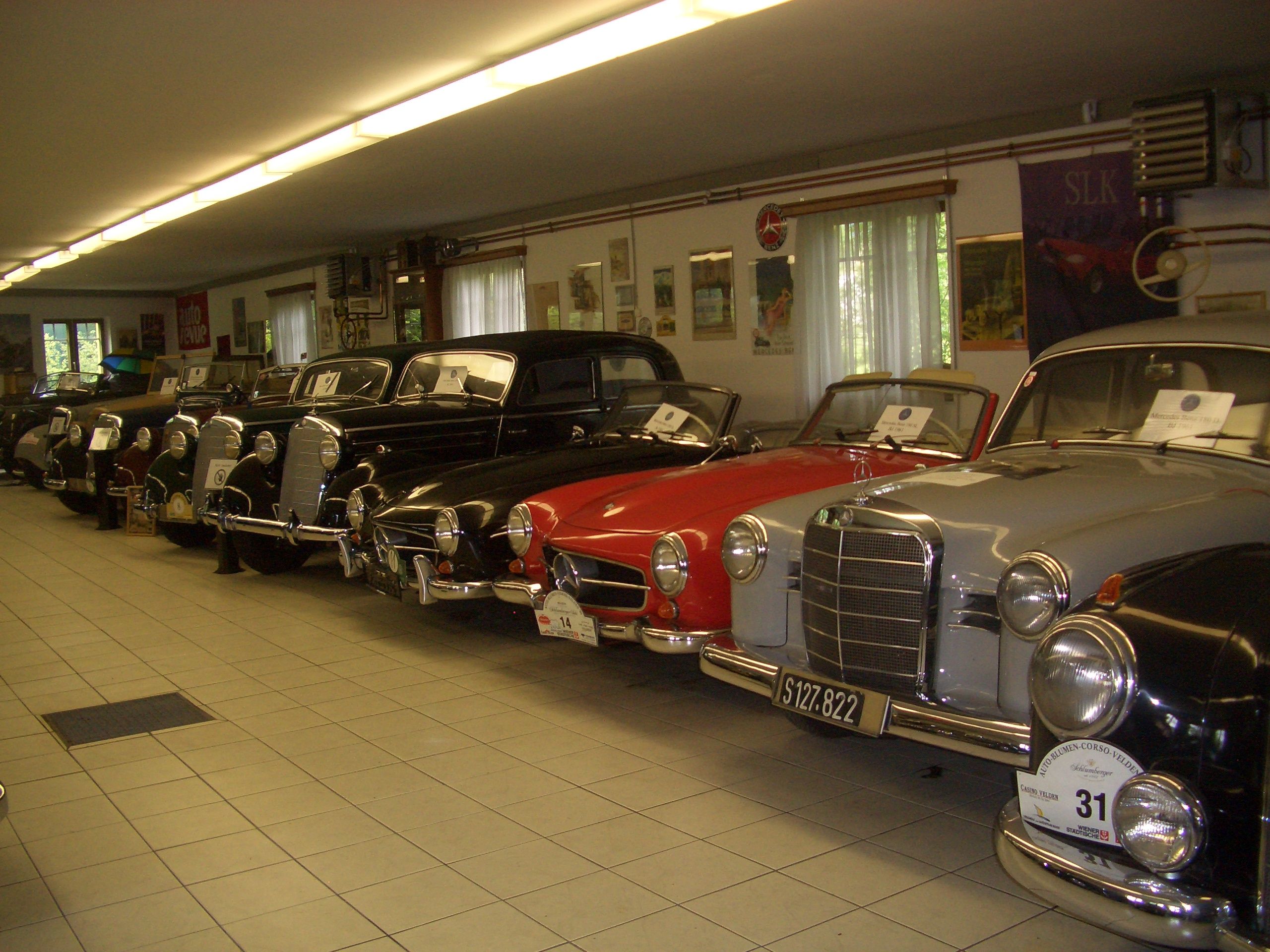 A row of vintage cars in a museum.