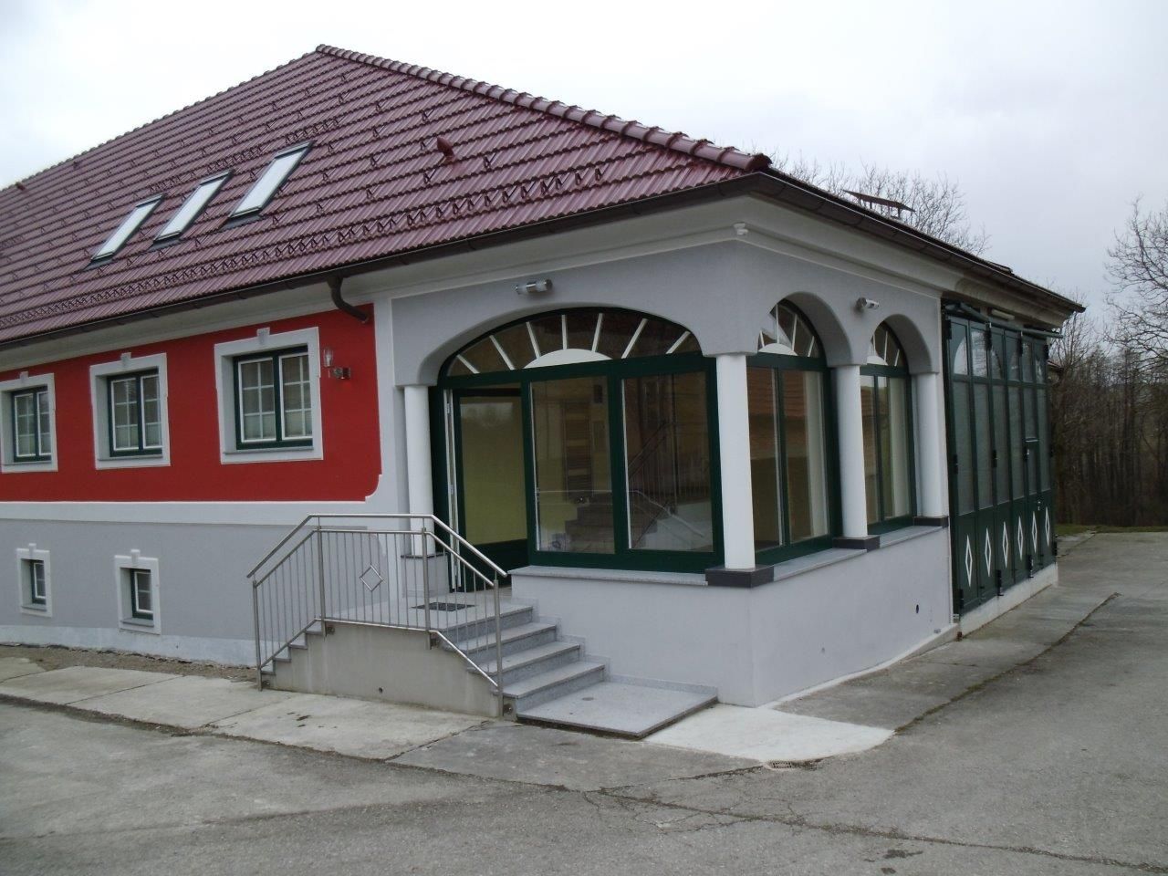 A modern building with a red roof and red façade.