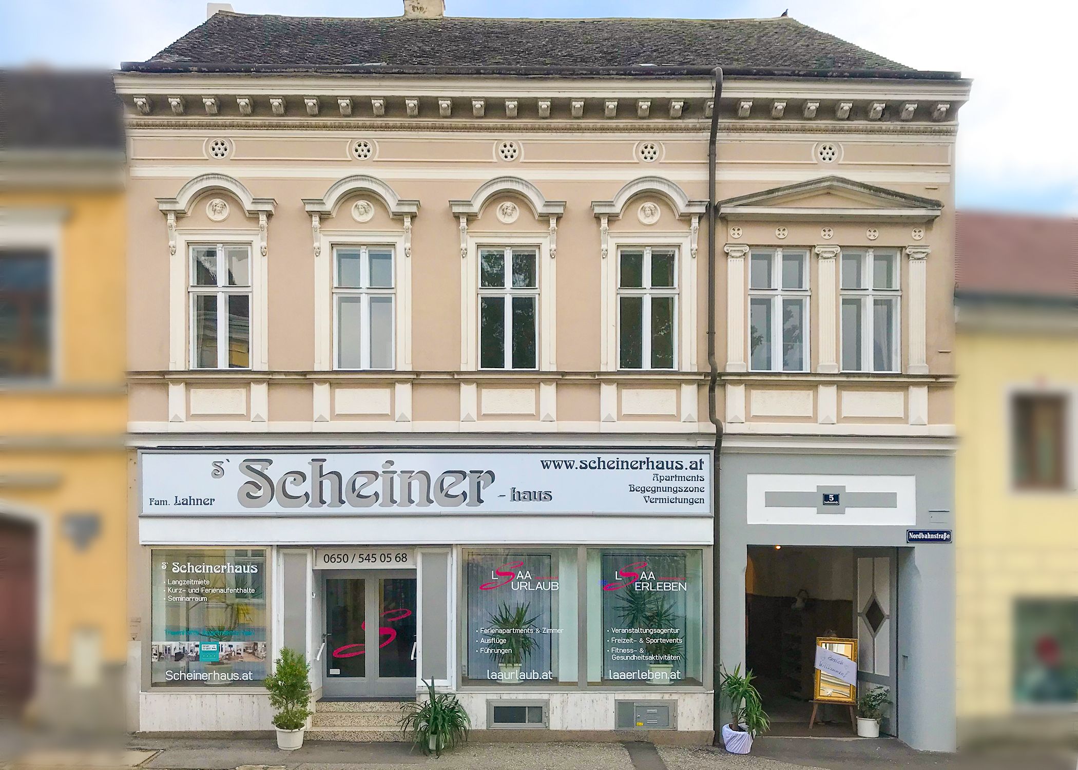 Façade of a two-storey building with the lettering 'Scheinerhaus'.