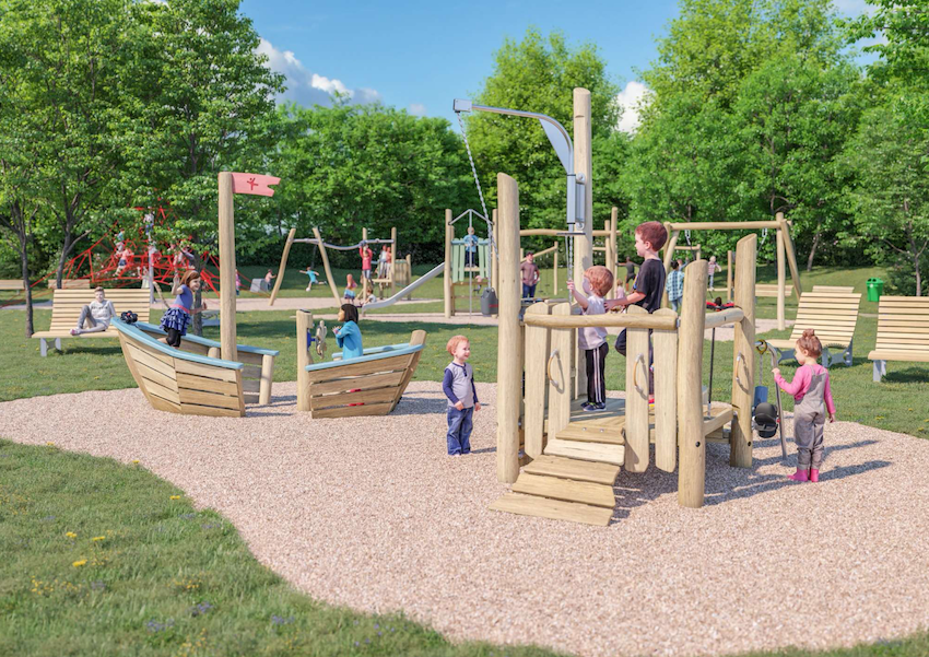 Children play on the large playground with wooden equipment and slides