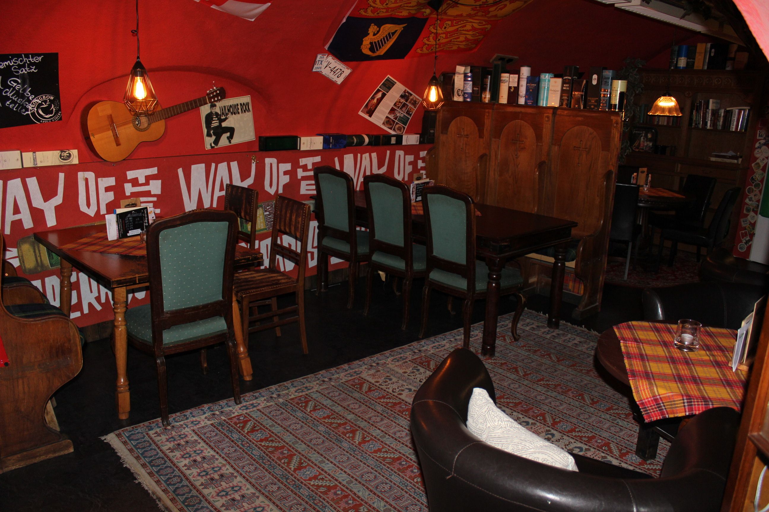 Cozy seating area in a café with wooden furniture and decorations on the walls.
