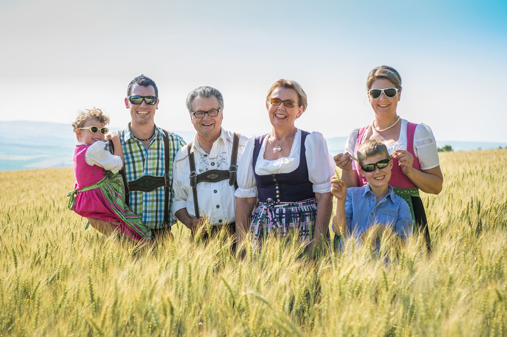 The Hopfeld family in traditional costume in a field.