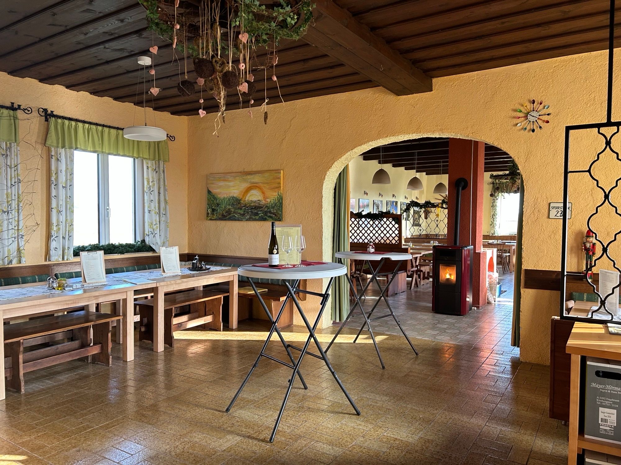 A bright dining room with wooden tables, benches, and rustic decor.