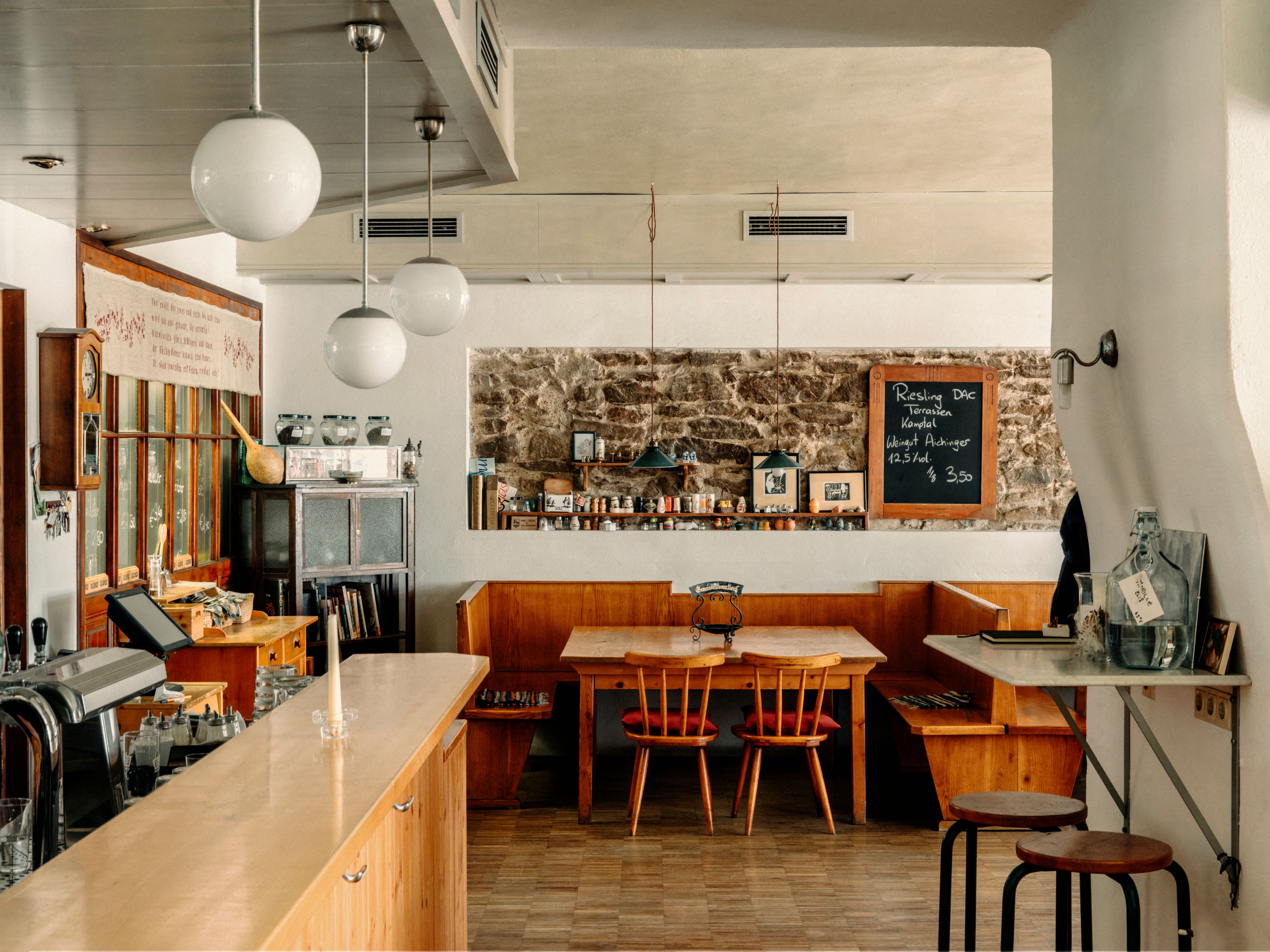 Three people in traditional clothing in a bright room.