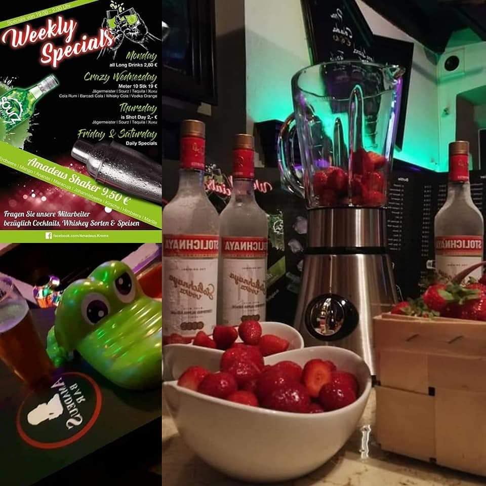 Bar with vodka bottles, strawberries and blender.