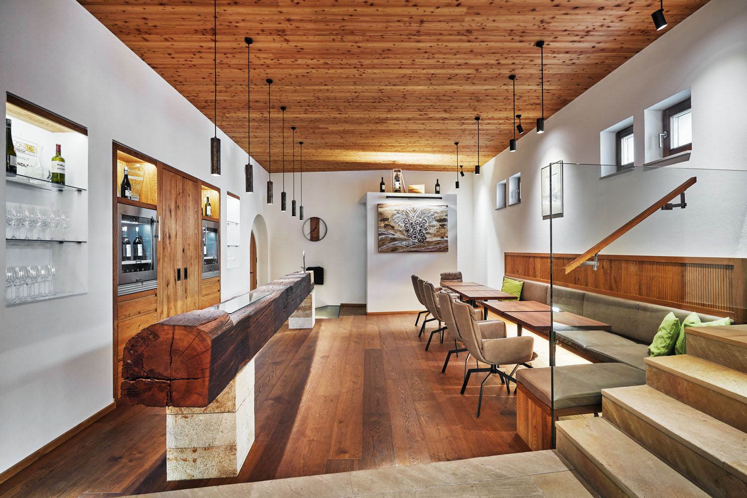 Interior view of a modern wine lounge with wooden elements, tables and chairs.