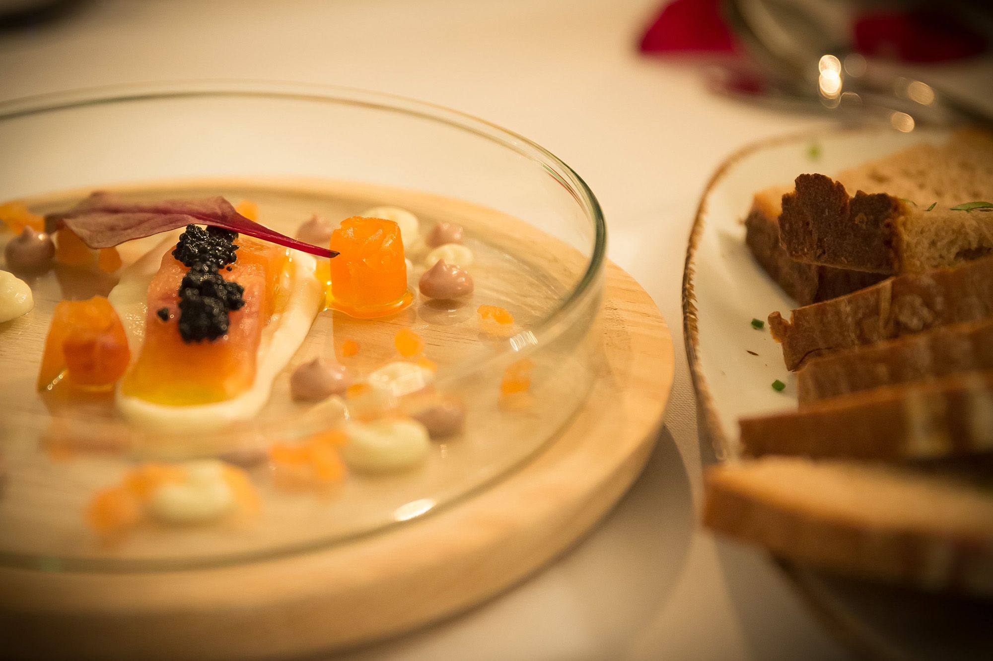 Home-pickled salmon trout with caviar and bread on a plate.