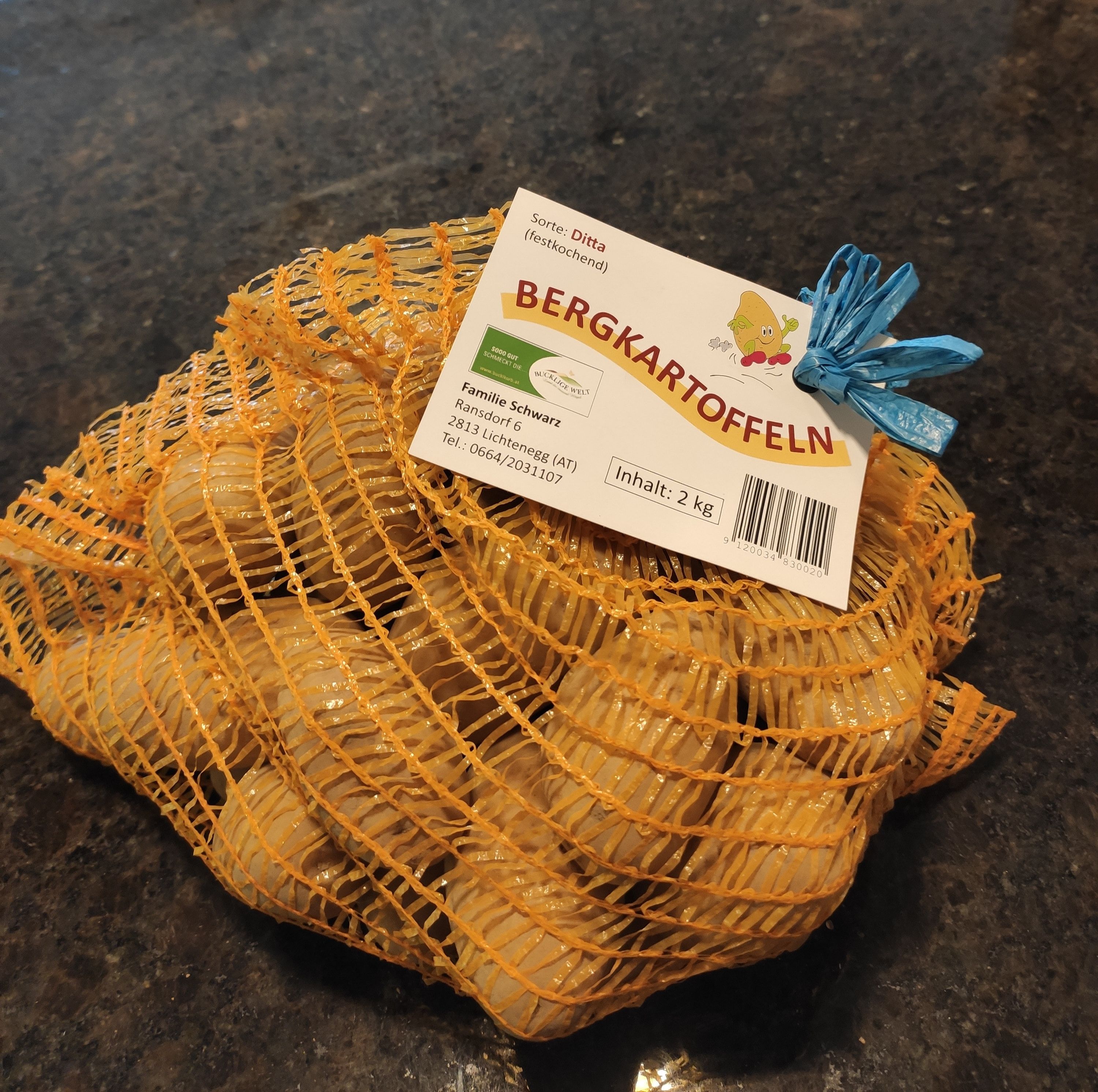A sack of mountain potatoes on a dark gray background.