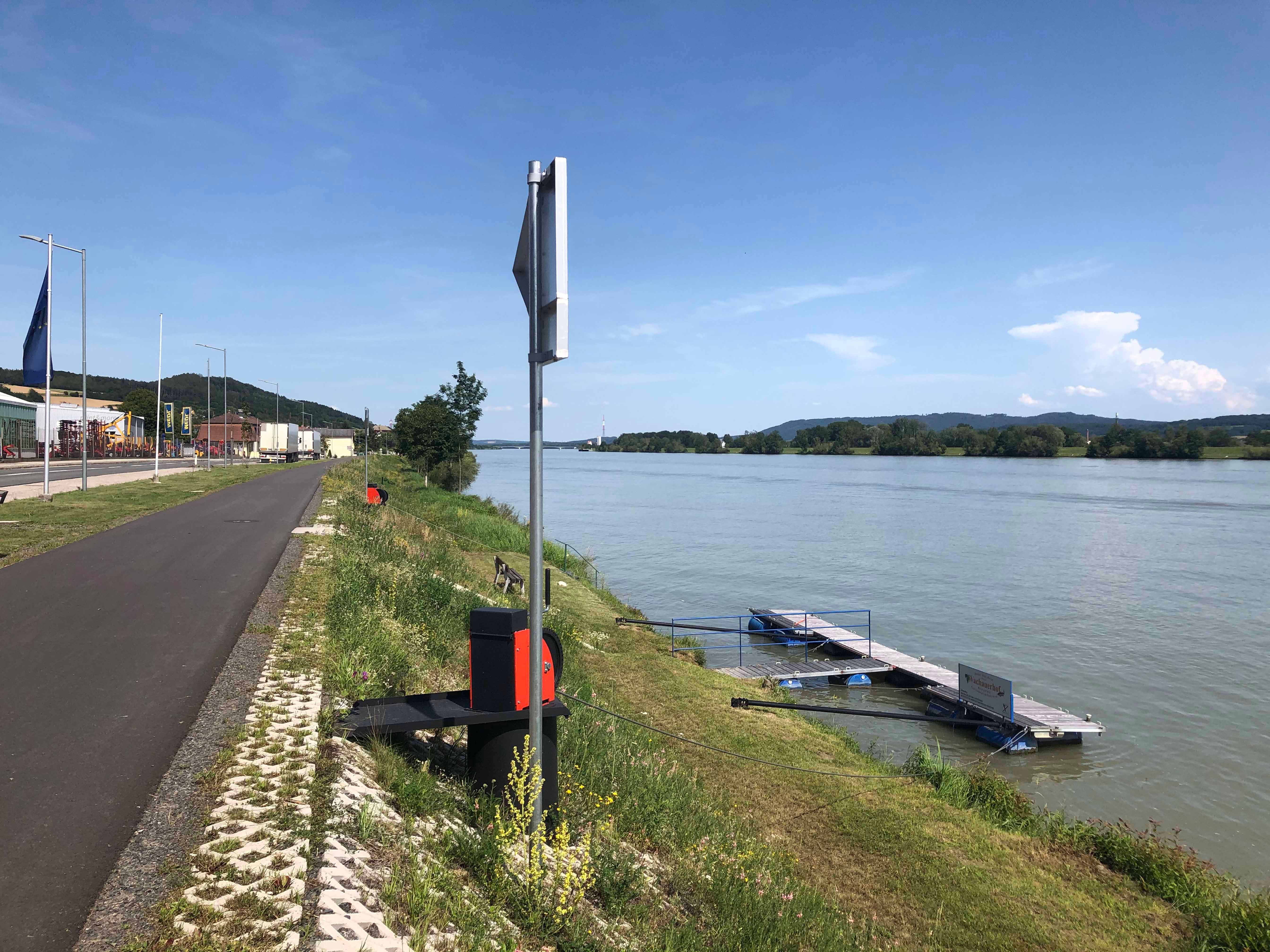 Jetty on the banks of the Danube in Marbach, surrounded by green countryside and blue skies.