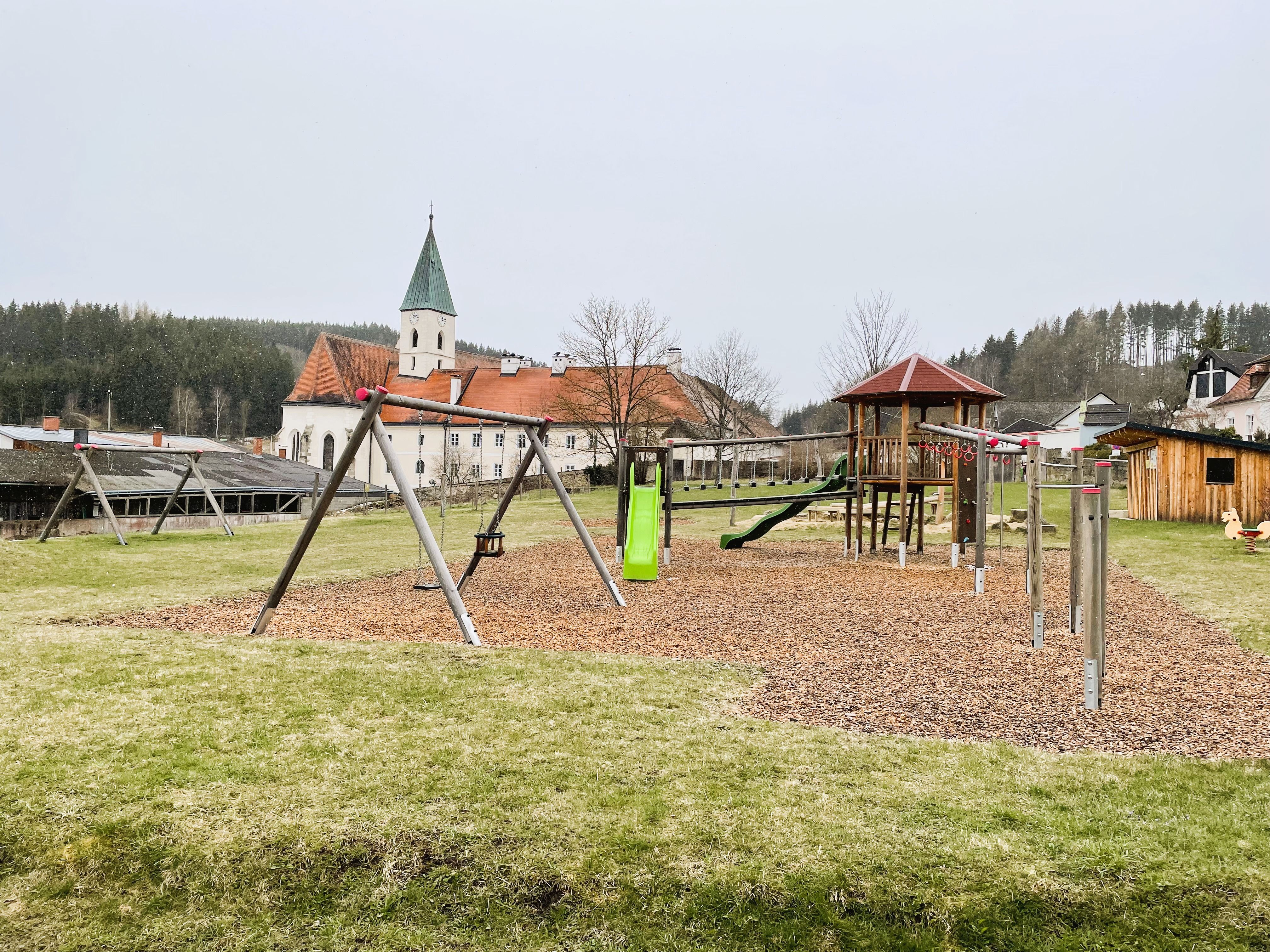 Playground with church in the background in Schönbach