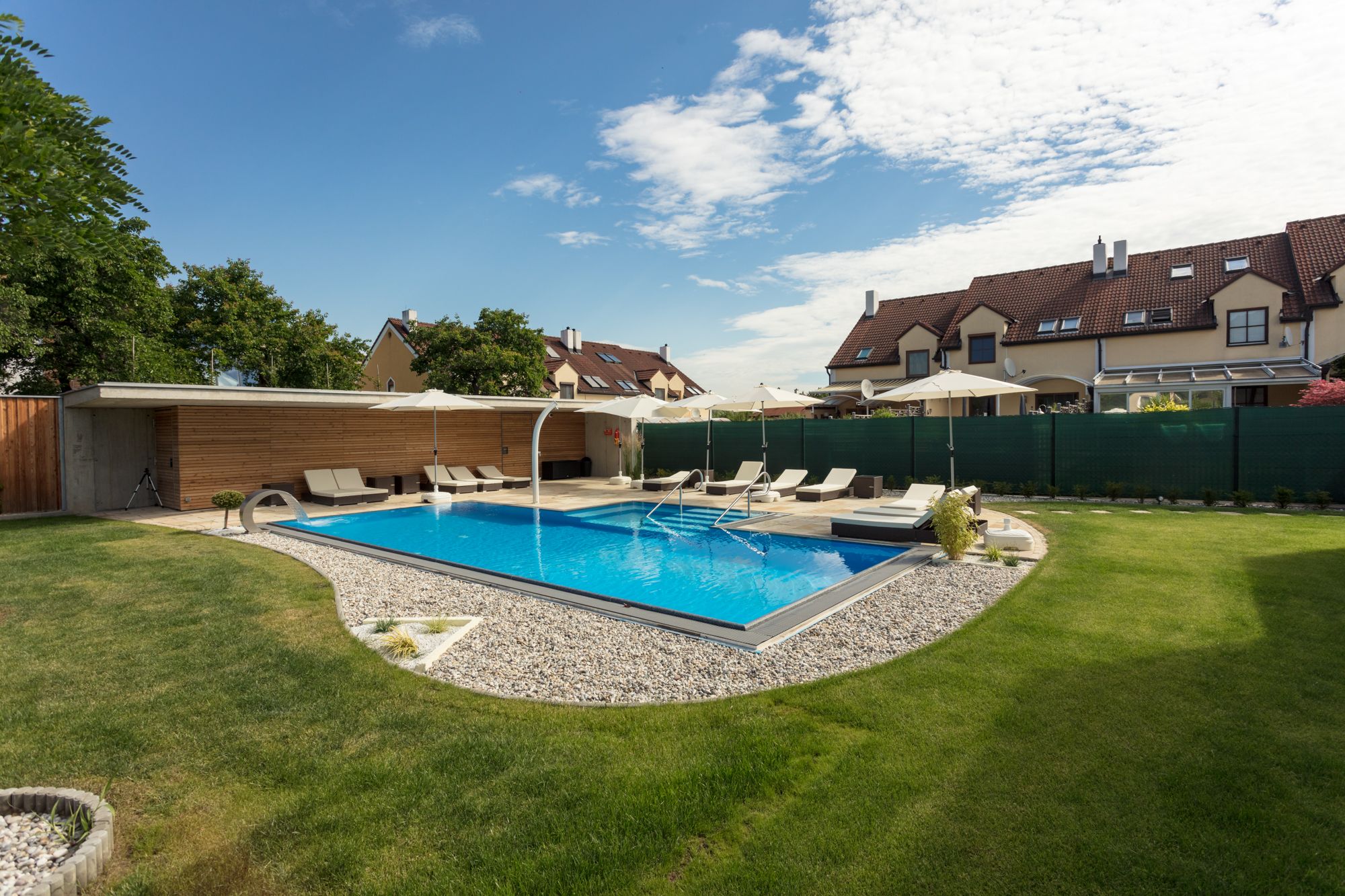 Swimming pool surrounded by green lawn