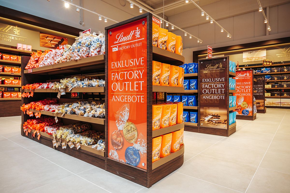Shelves of Lindt chocolate in an outlet.