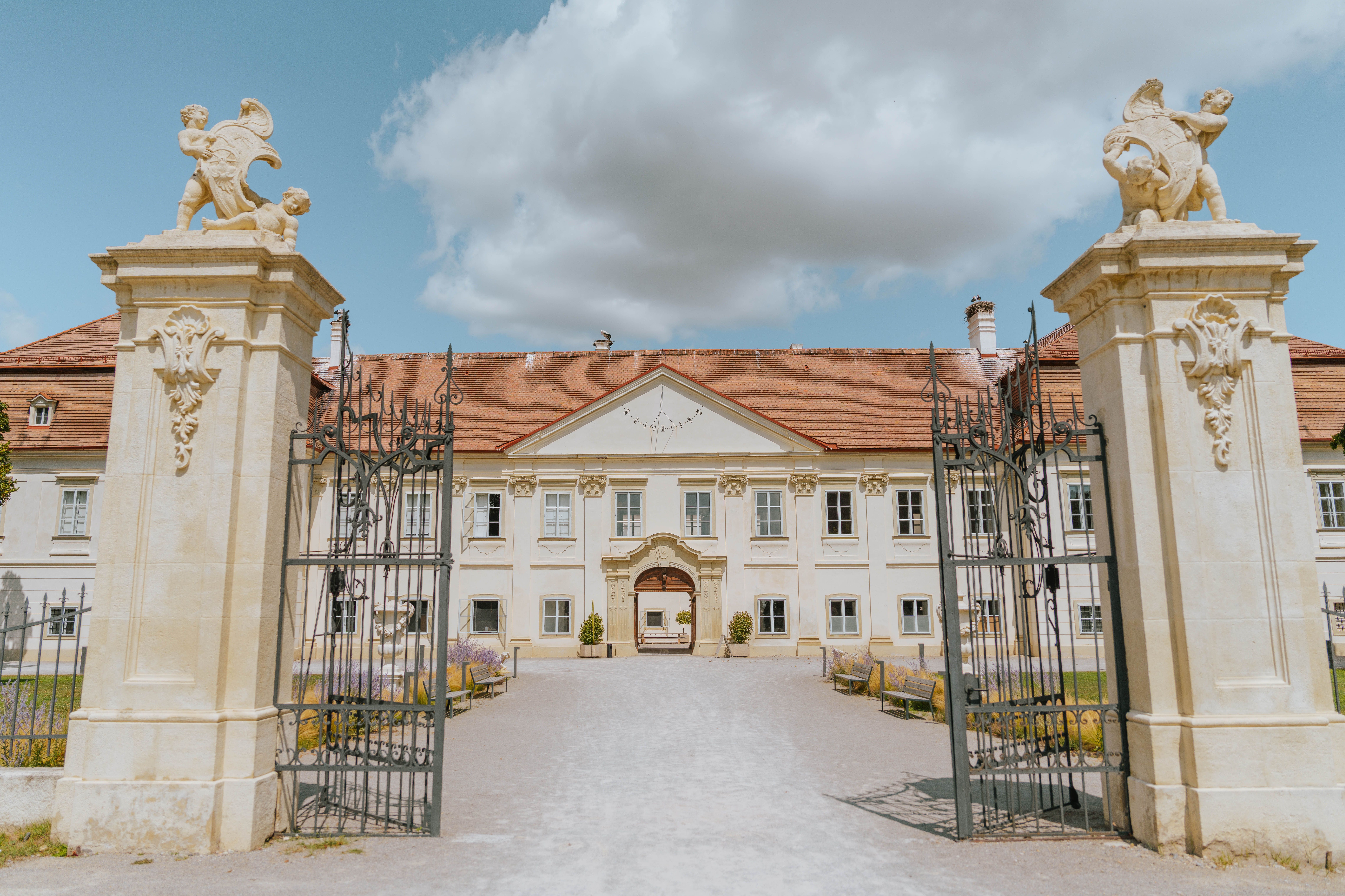 Entrance gate and façade of Marchegg Castle under a blue sky.