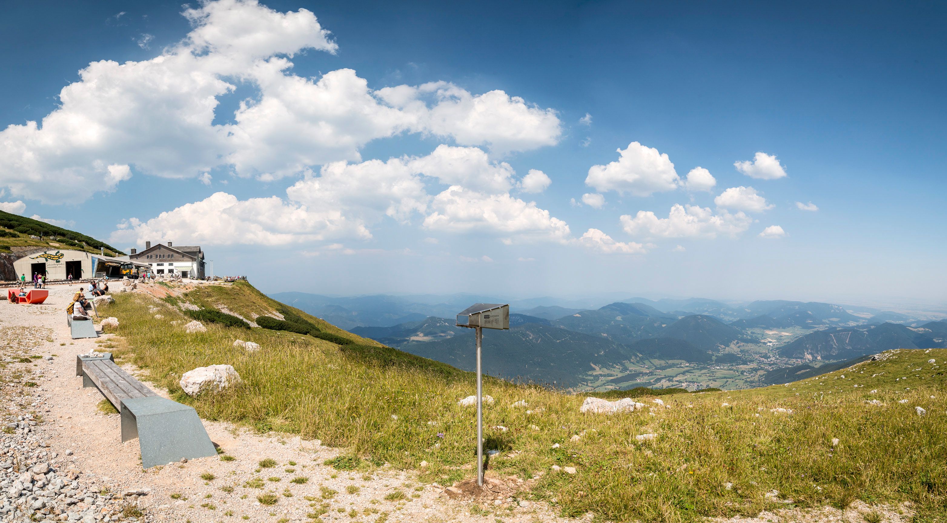 View from Schneeberg with mountain landscape and huts.