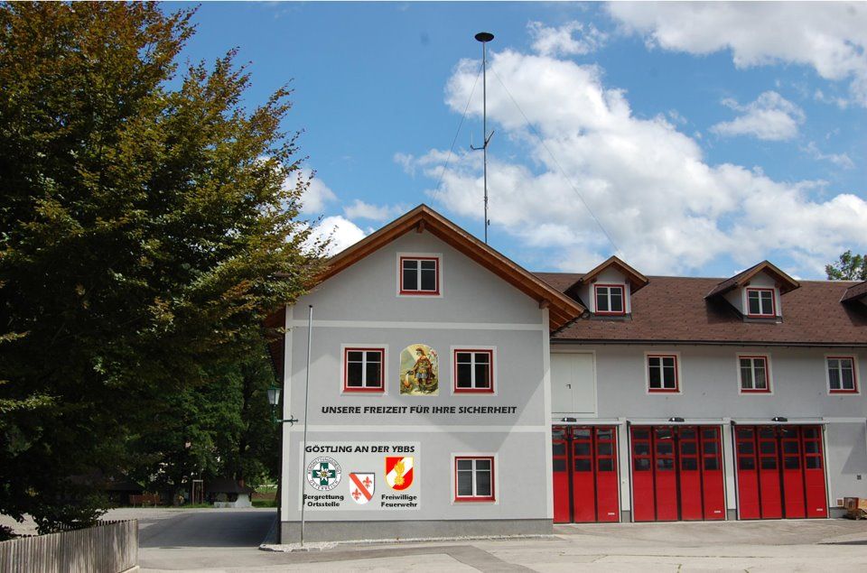 Fire department building with red gates and lettering 'Our free time for your safety'.