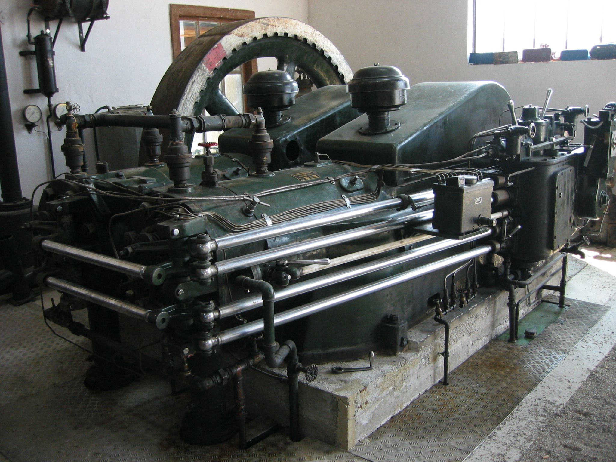 Old industrial engine on display in a museum.