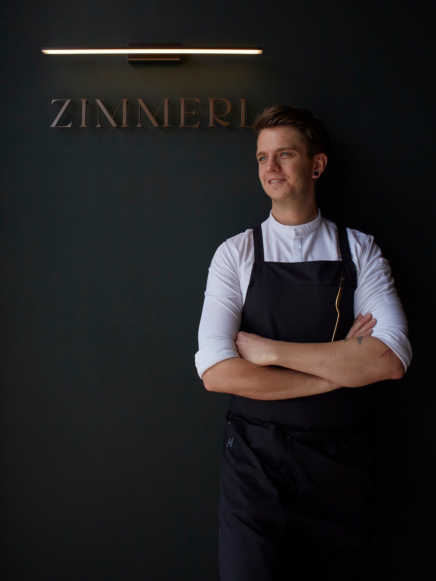 Elegant restaurant with round tables, white tablecloths and subdued lighting.