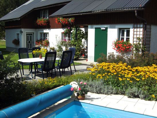 Vacation home with garden, pool and flowers.