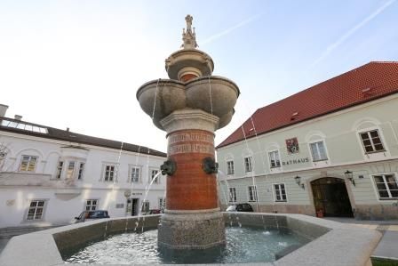 Emperor Franz Josef Jubilee Fountain in front of a town hall building.