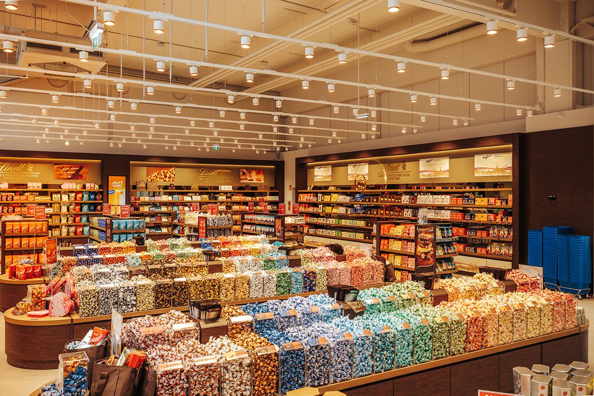 A large confectionery store with colorful chocolates and chocolate shelves.