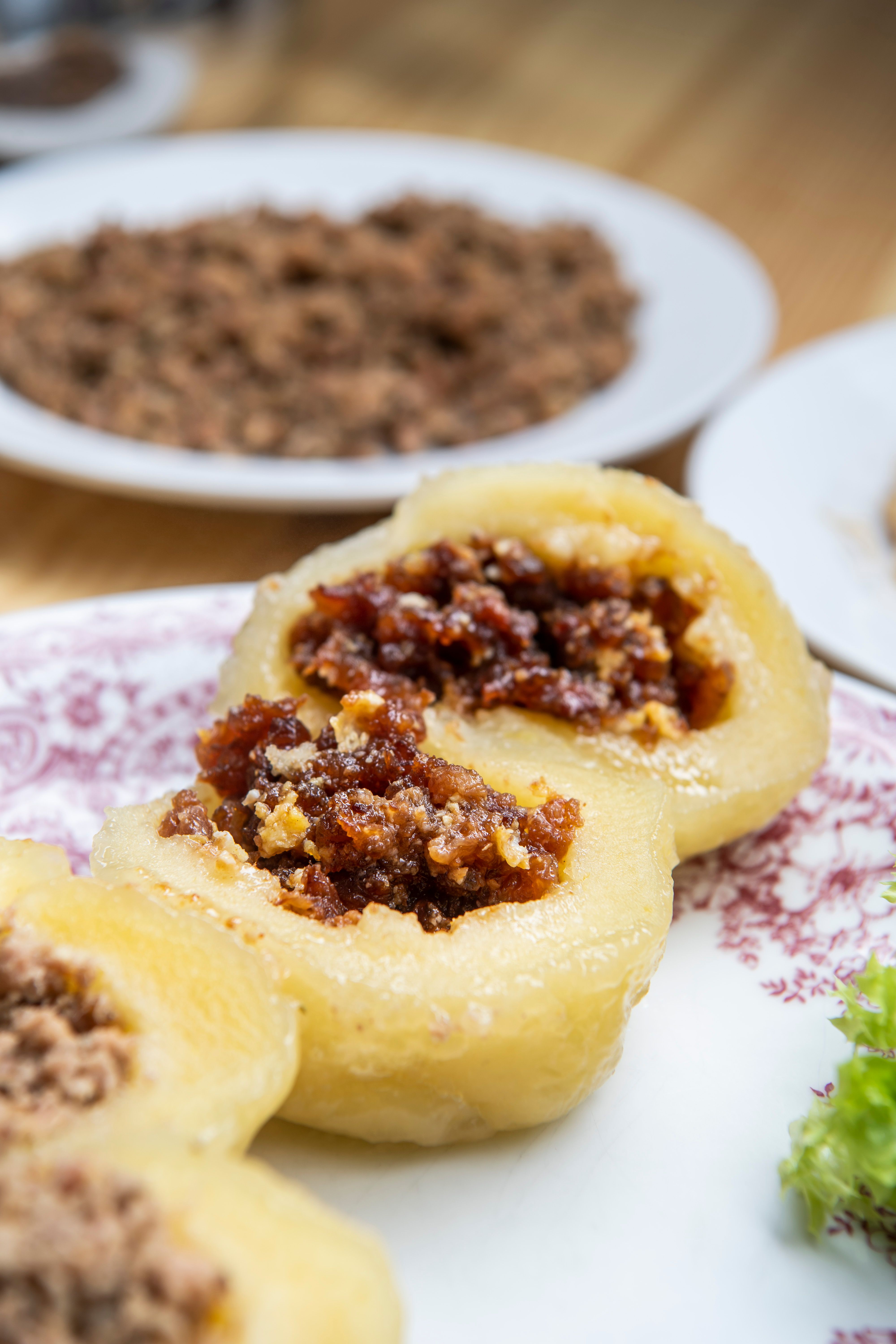 Close-up of filled dumplings on a plate with decoration.