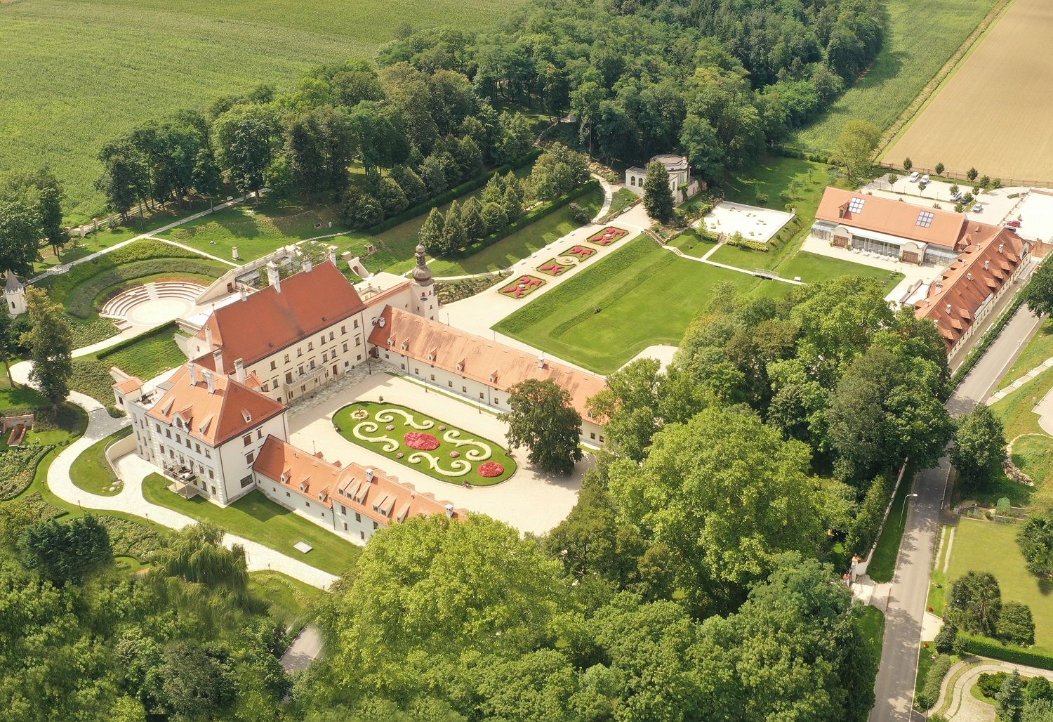 Aerial view of Schloss Thalheim with surrounding gardens and buildings.
