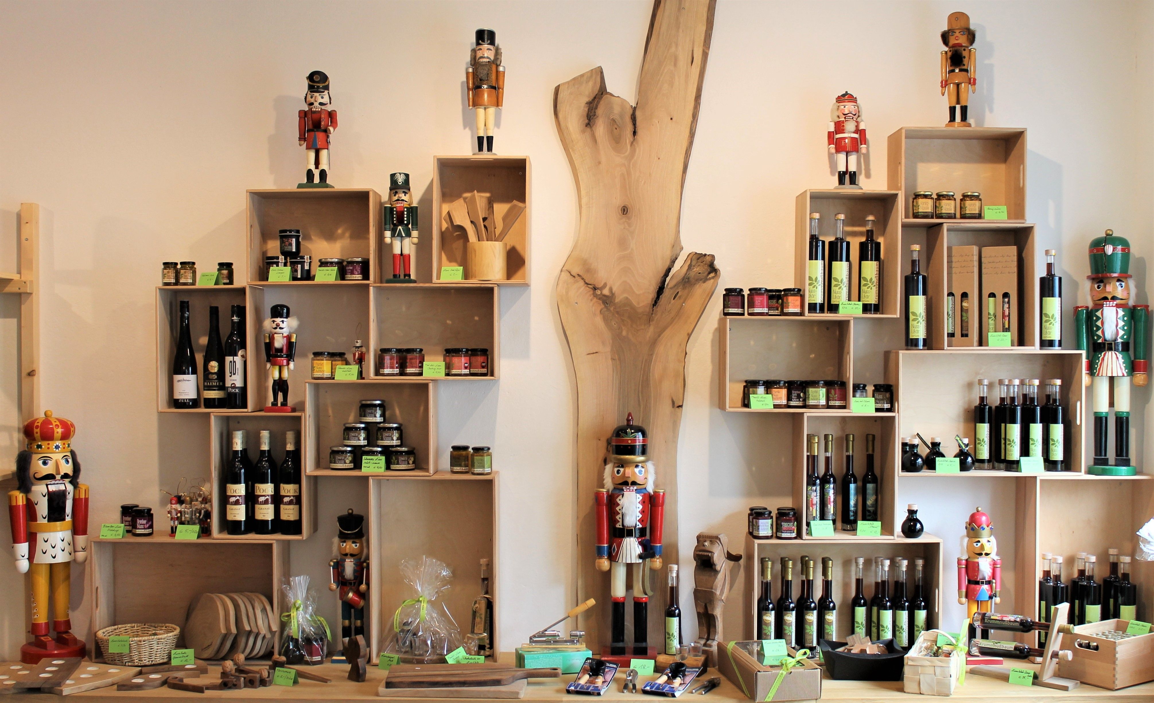 A store shelf with nutcrackers, bottles of wine and gourmet products.