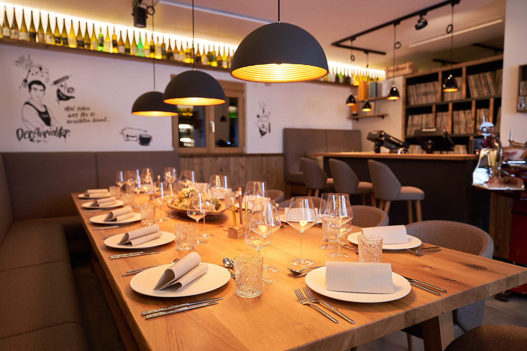 Elegant table setting in a stylish restaurant with warm lighting and modern decoration.