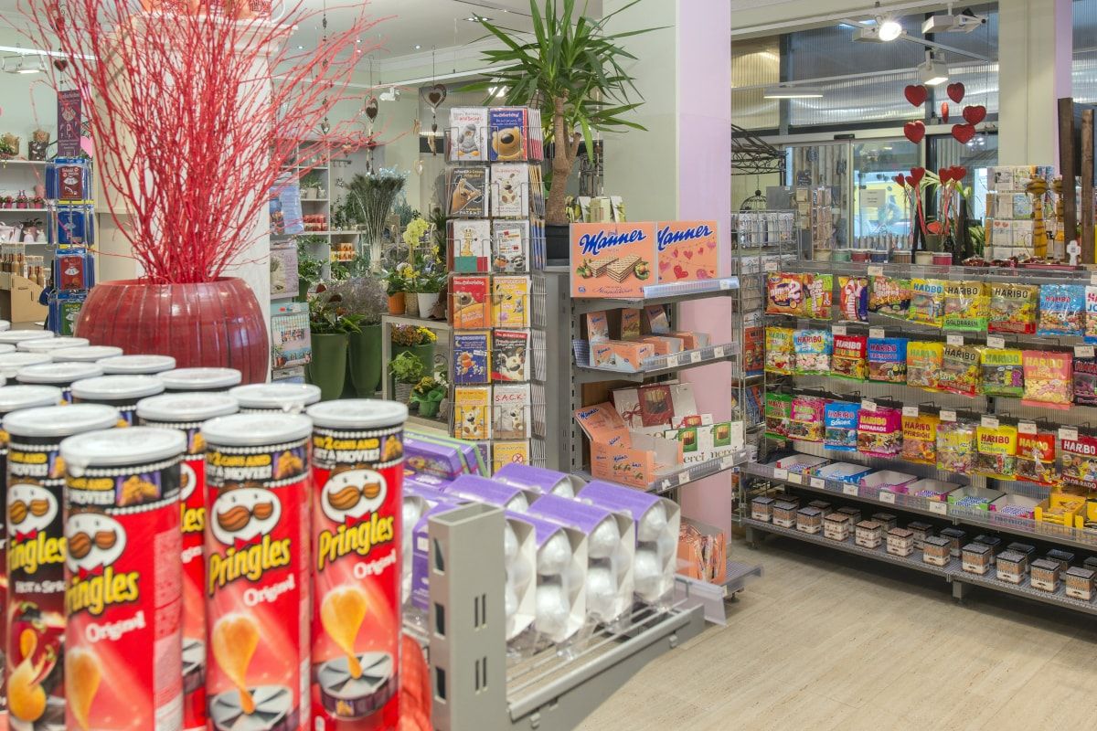 The SHop with lots of sweets. In the foreground are stacked chips.