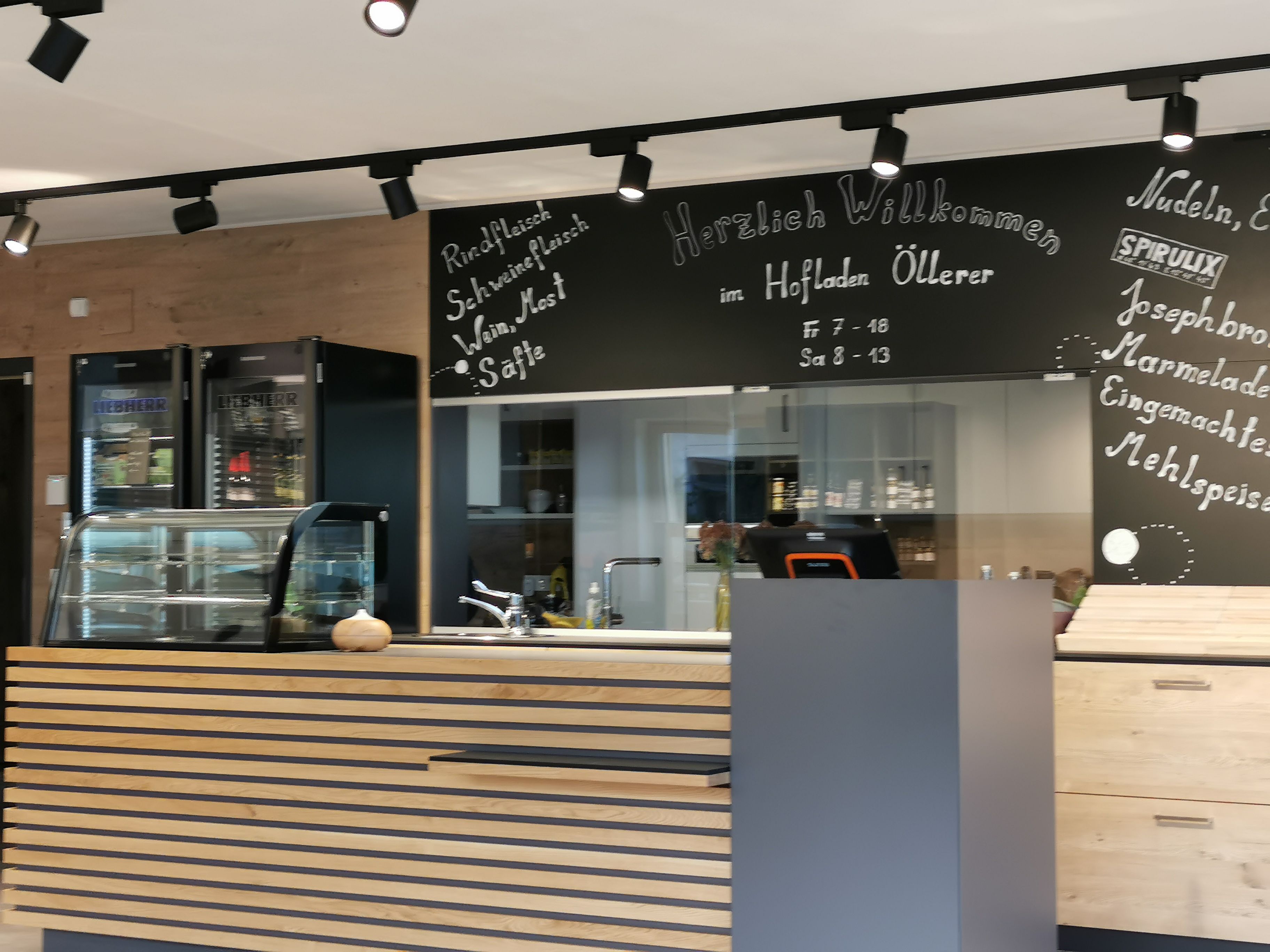 Detailed view of the farm store. Counter and behind it is the offer on a chalkboard.