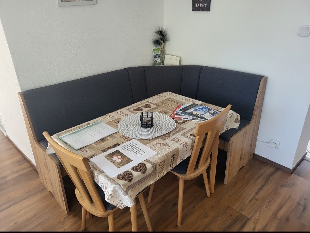 Dining area with corner bench and table in a vacation apartment.