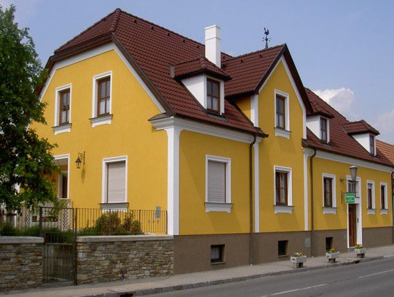 Yellow detached house with red roof