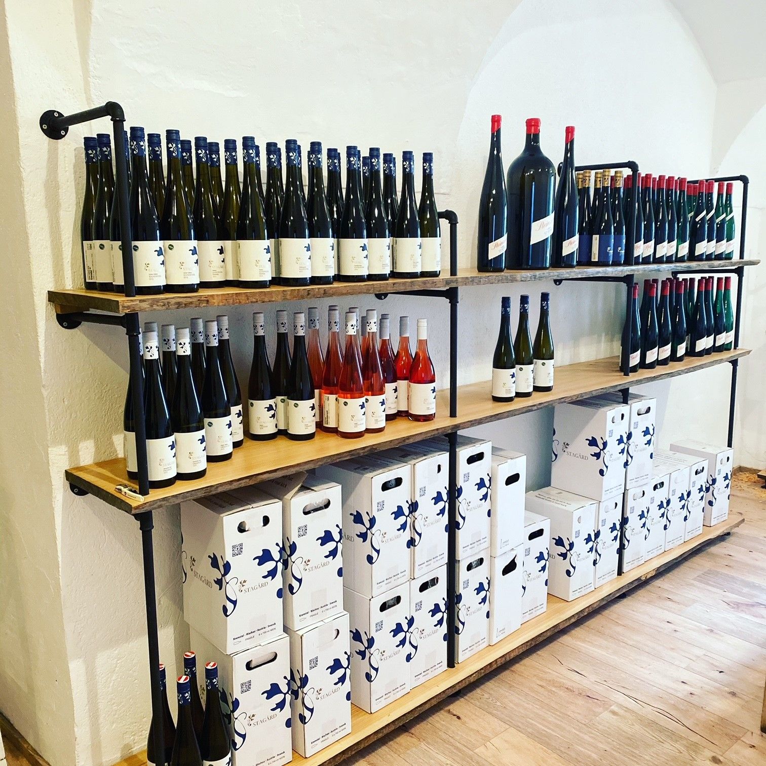 Shelves with wine bottles and boxes in a wine shop.