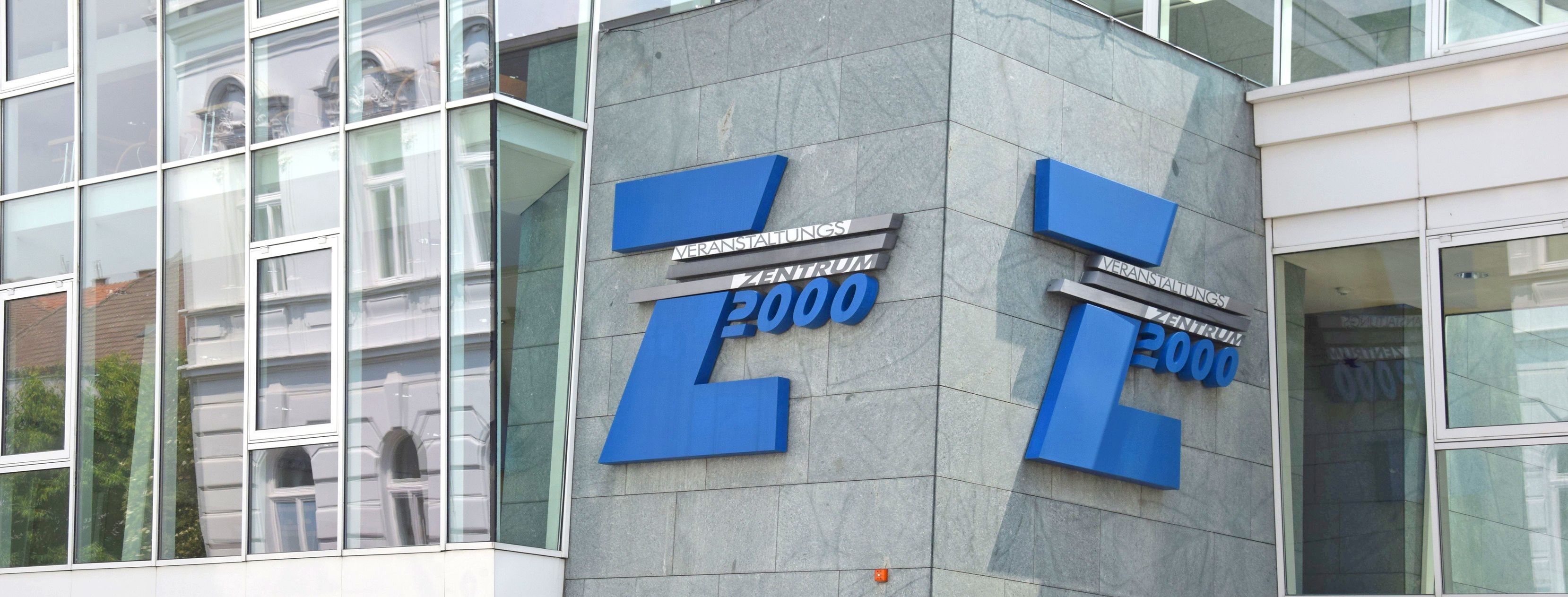 Entrance to the Z2000 event center with blue logo on grey façade.