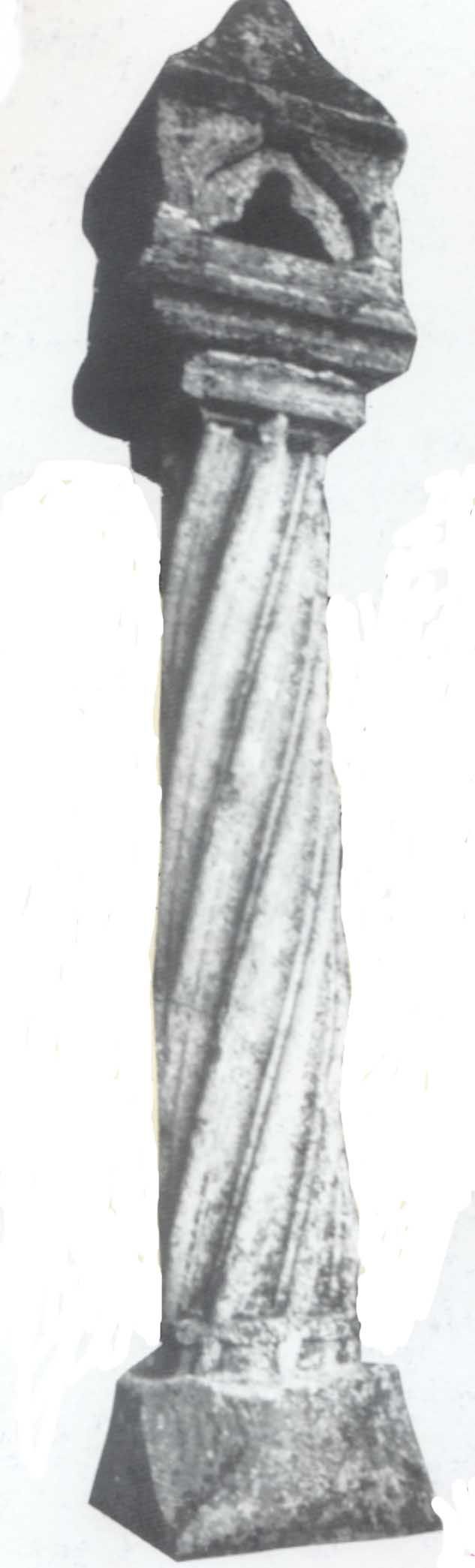 Stone column with twisted pattern and cross motif.