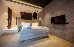 Interior view of a modern restaurant with large windows and a view of wooded hills.