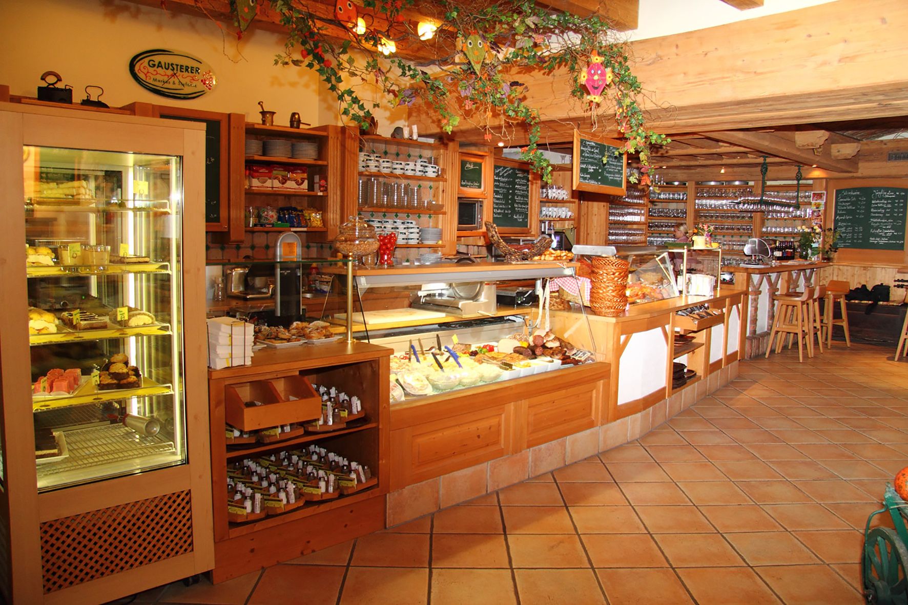Interior view of a cozy café with counter and displays.