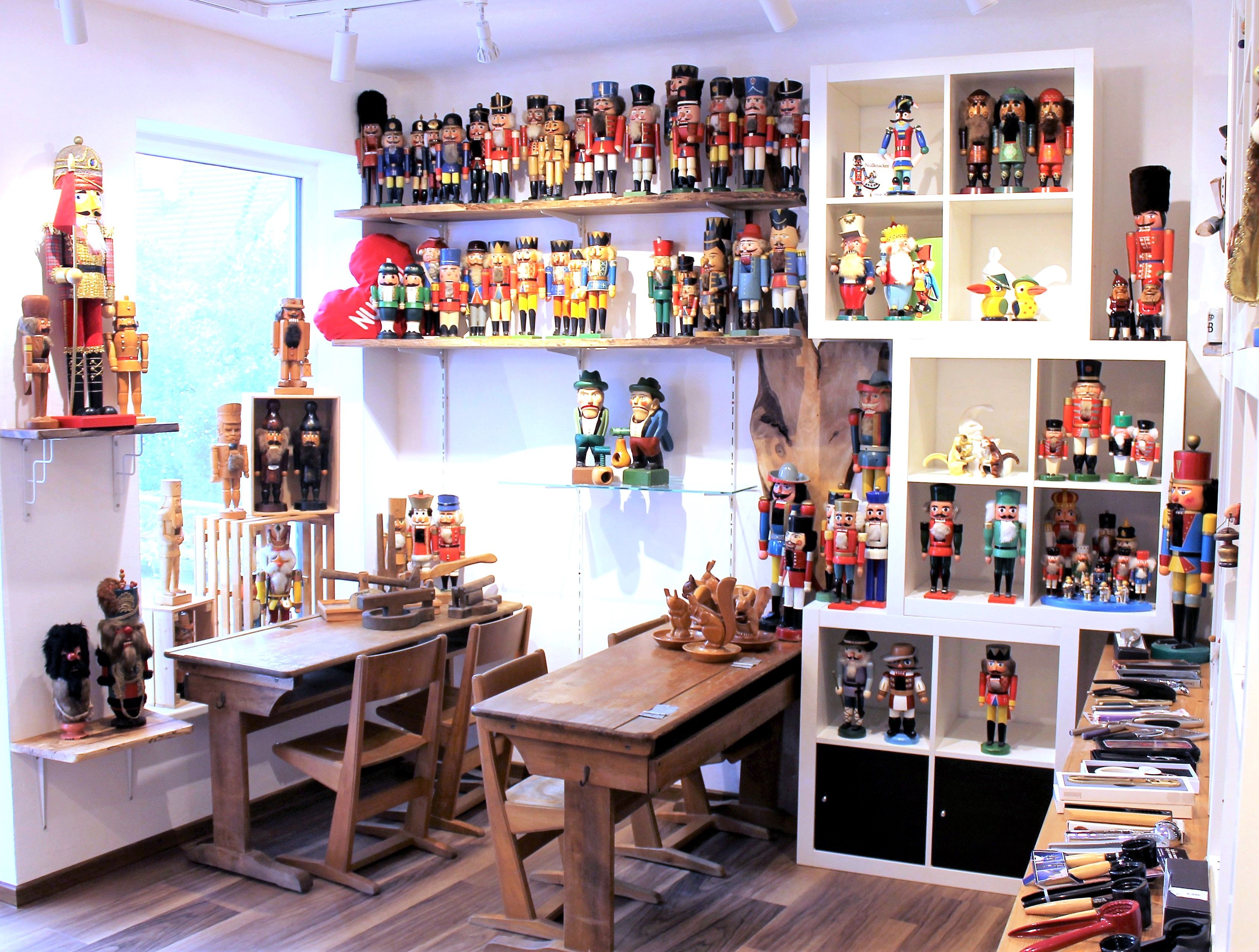 Room with nutcracker figures on shelves and tables.