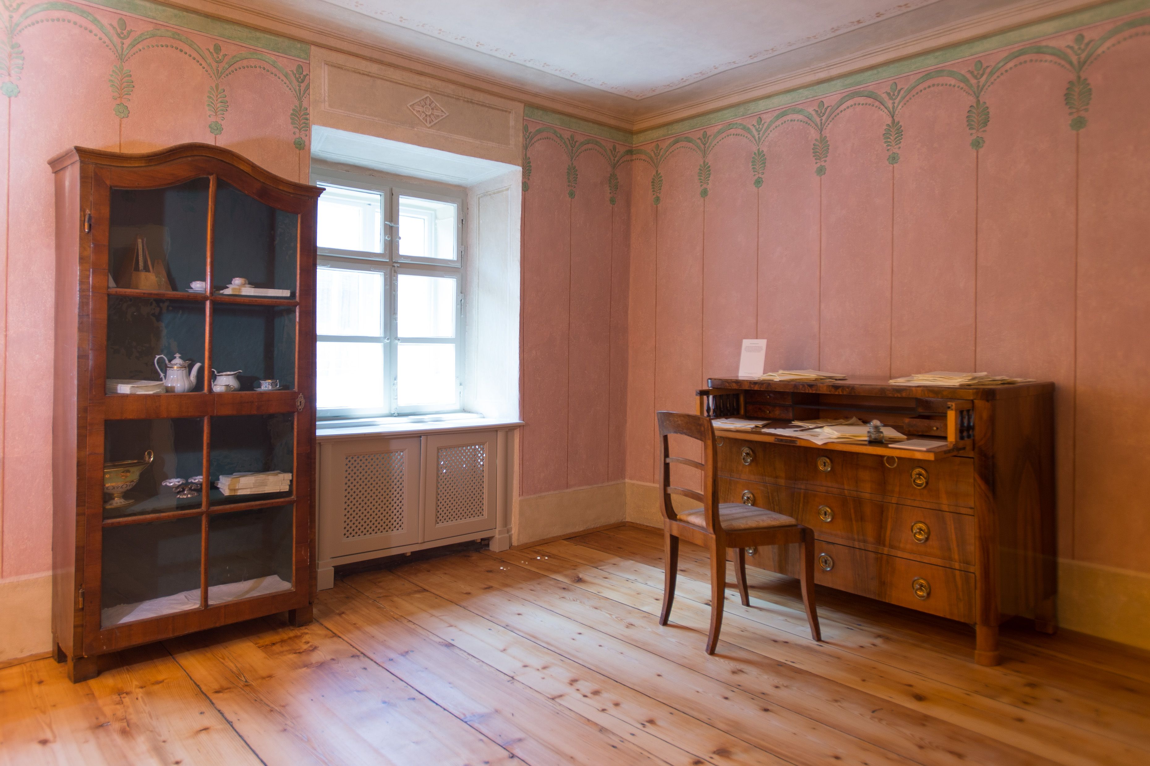 Historic room with antique cupboard and desk.