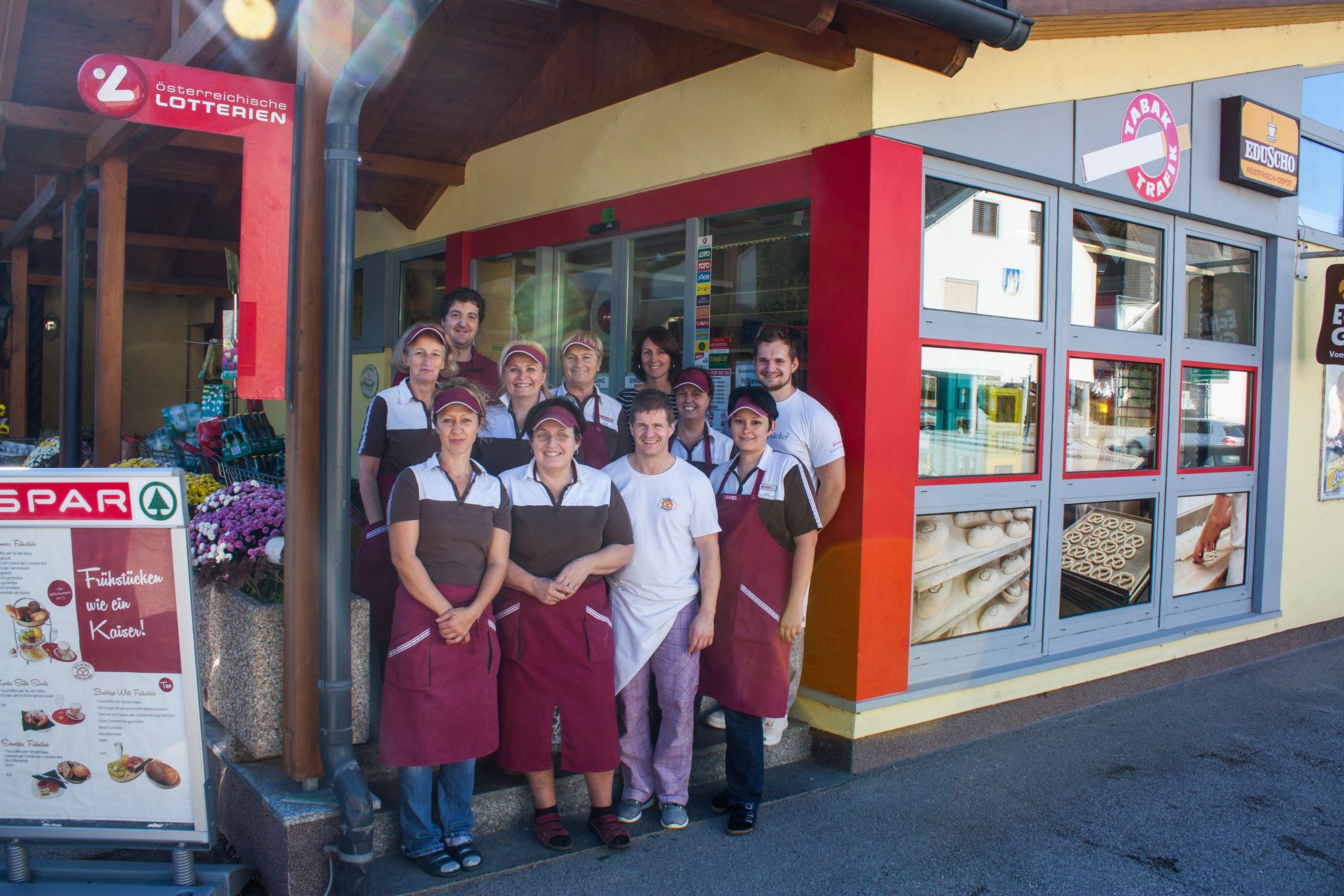 A group of people in work clothes in front of a store.
